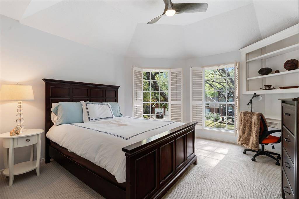 Comfortable secondary bedrooms, this is one of 3 that offers large picture windows with plantation shutters and a built-in desk area.