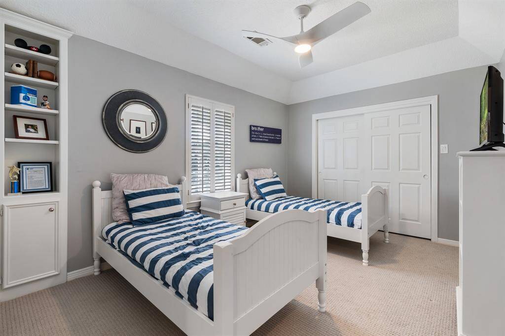 This last but definitely not least bedroom affords a built in niche with additional storage, neutral carpet and sliding closet door that opens into an oversized closet and attic access.