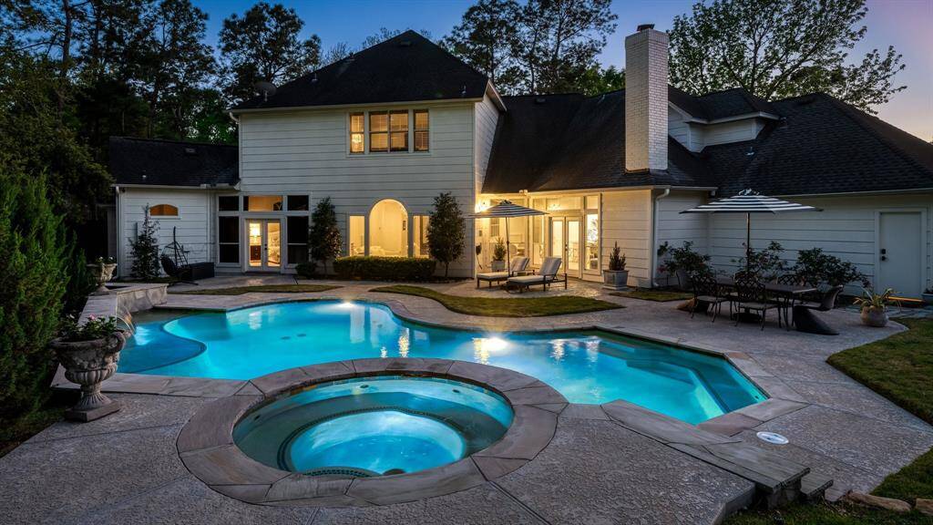 The spacious backyard complements the home's durable Hardi Plank exterior and features French drains, a sprinkler system, and a convenient gas line, perfect for adding a summer kitchen.