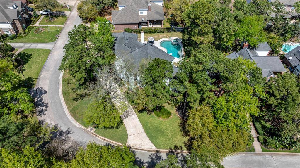 The oversized corner lot features a spacious circle drive, offering ample parking and easy access for guests.