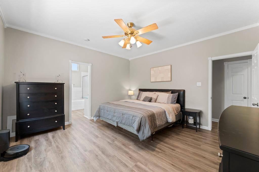 Spacious primary retreat with a ceiling fan and gorgeous en-suite