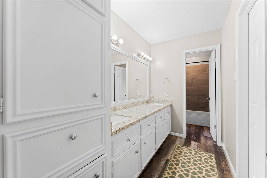 Full bath features granite countertops and new flooring.