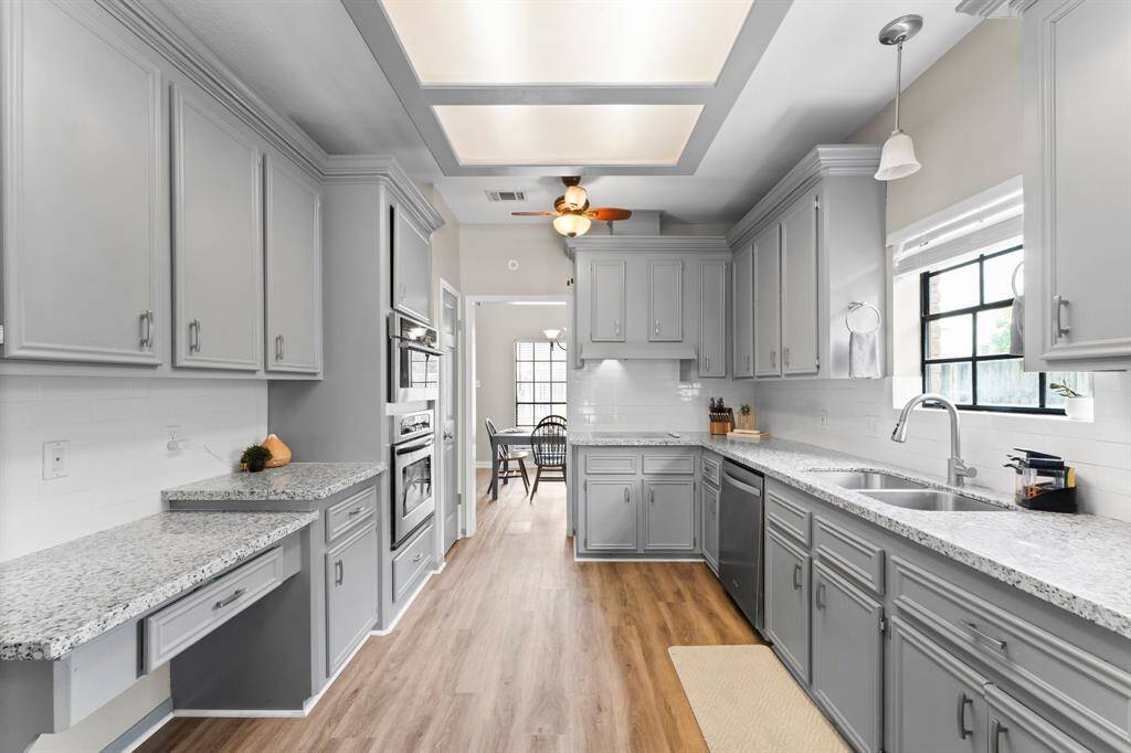 Kitchen boasts stainless steel appliances, subway tile and plentiful cabinet space.