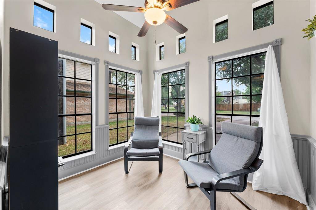 Front room features beautiful floor to ceiling windows.