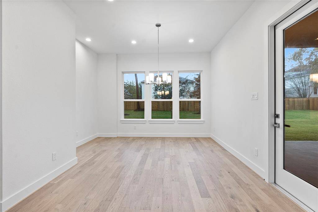 Breakfast Room with Views of the Wooded Back Yard and Access to the Covered Rear Patio.