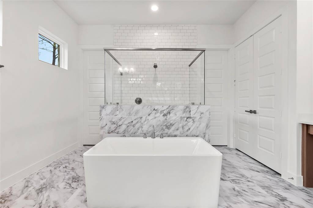 The Primary Bath Looks More Like a Luxury Hotel and Includes a Freestanding Tub, Separate Shower, and Linen Closet.