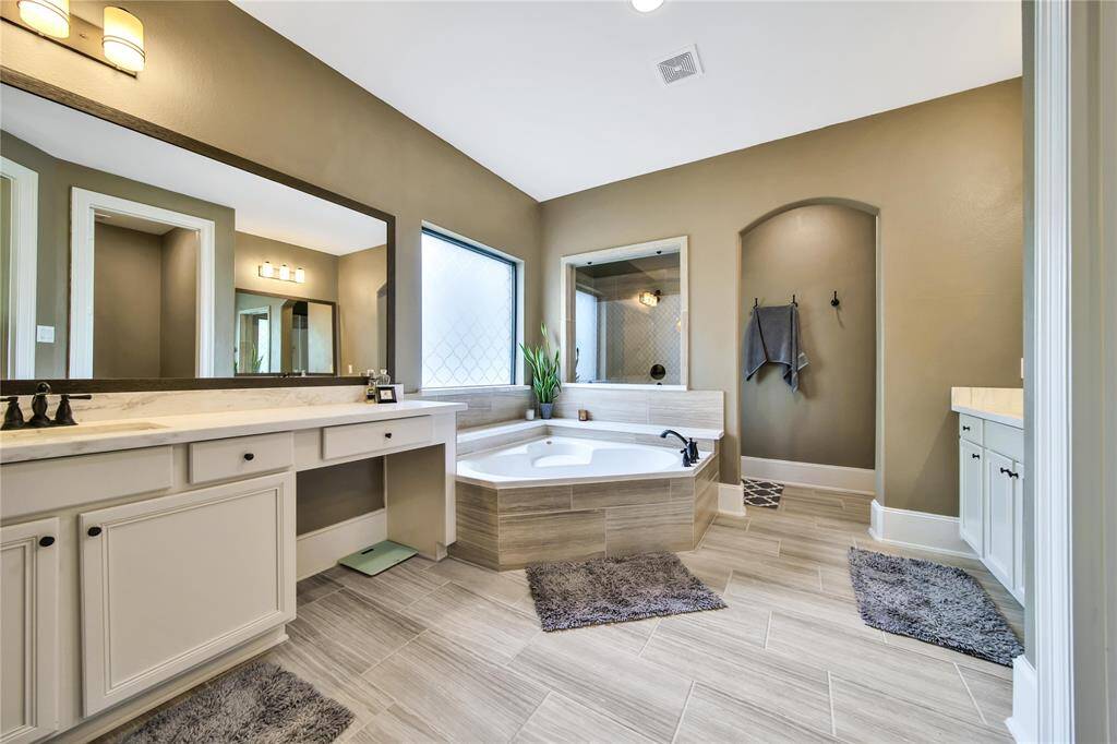 Primary bath includes vanity and His and Her closets