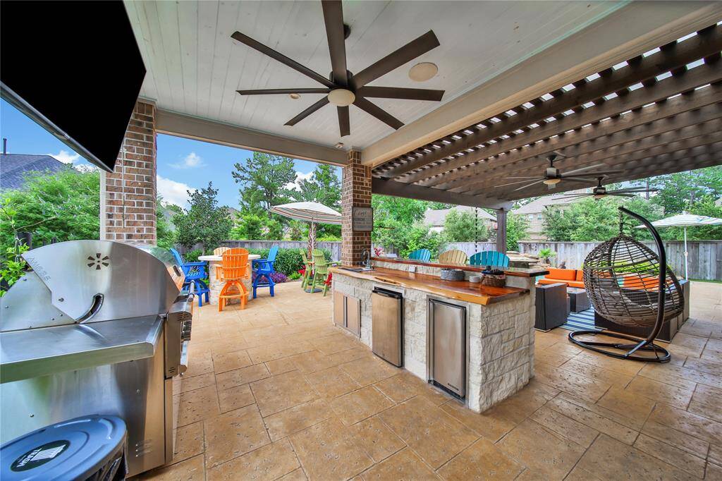 Custom wet bar is equipped with ice machine and fridge.