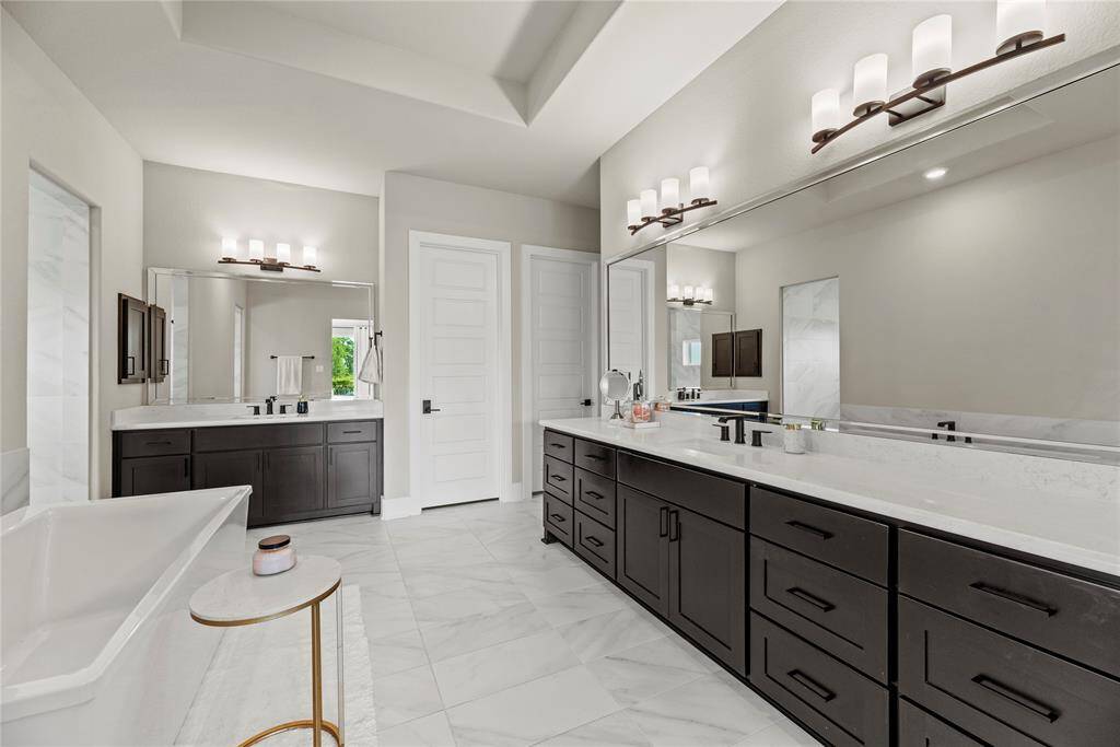 Dual sinks complete the primary ensuite with highly functional style. With dedicated mirrors and counter space for each partner, the early morning rush is manageable and simple.