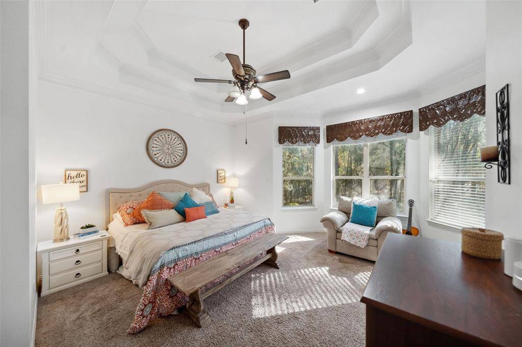 PRIMARY BEDROOM Copper valences, tray ceiling plus room for a sitting area. Secluded location overlooks the back of the home.