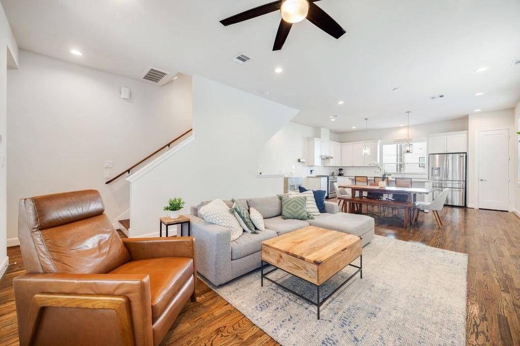 Rich hardwood floors and abundant natural light create a calm and serene atmosphere throughout the living space.