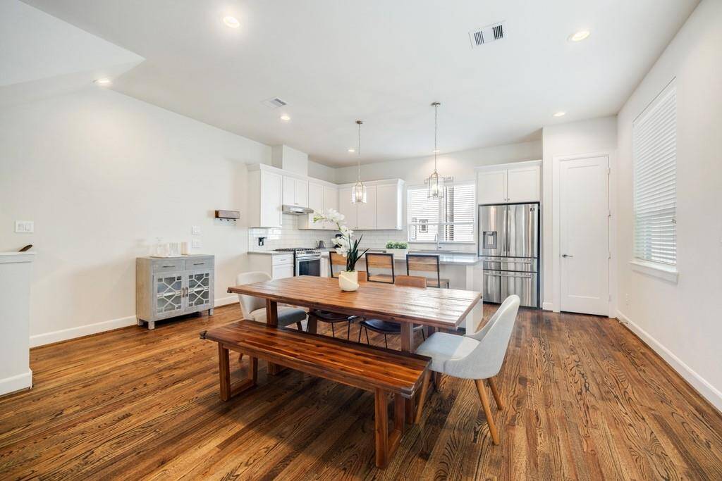 The stunning kitchen features a timeless subway tile backsplash and a built-in wine refrigerator for added style and functionality.