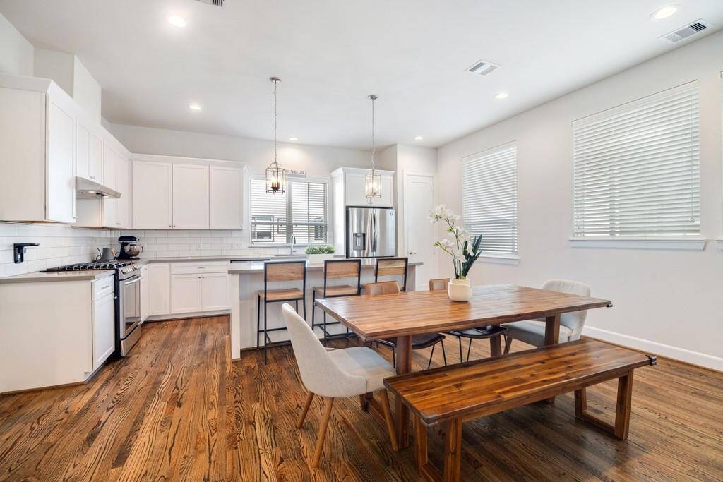 Beautiful kitchen offers a breakfast bar island, stainless steel appliances, quartz countertops, and abundant storage space.