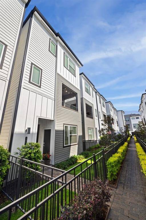 The gated community also offers a fully fenced front yard and a second-floor balcony for added outdoor living space.