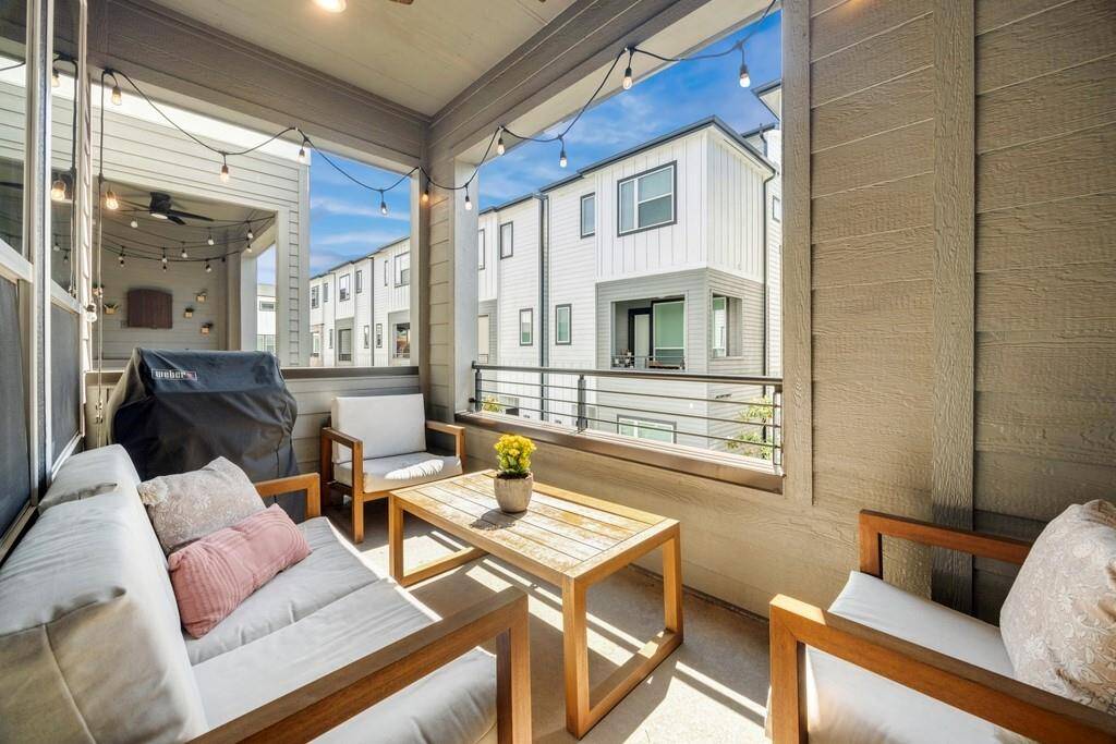 The third-floor primary suite features a tray ceiling, abundant natural light, and generous space, including two walk-in closets.