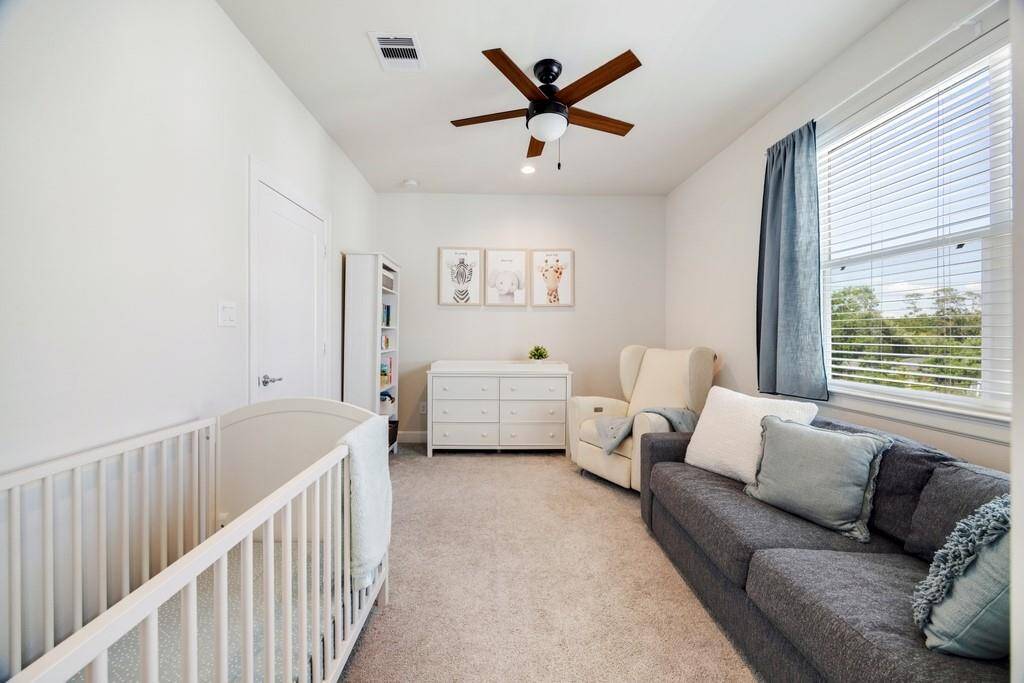 The primary bathroom features elegant double vanities, offering ample space and convenience.