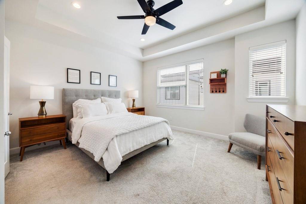 The spa-like primary retreat features a sleek frameless glass shower for a modern, luxurious touch.