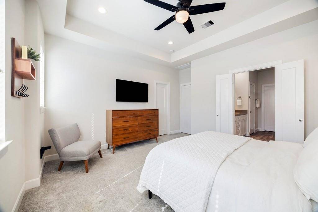 The secondary bedroom on the third floor features its own en suite bath for added privacy and convenience.