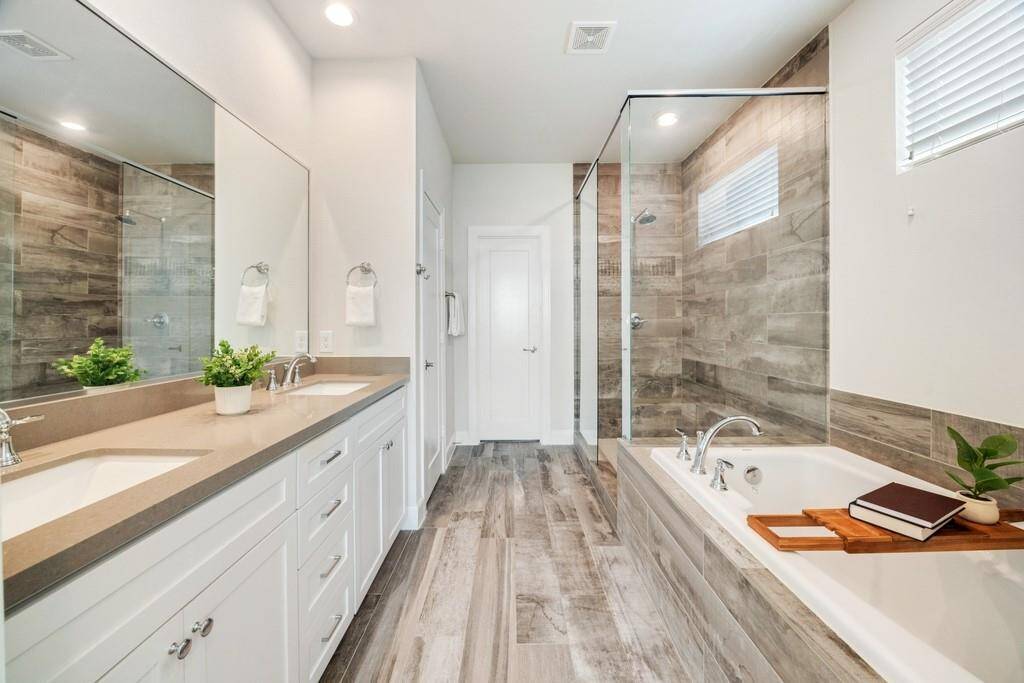 The secondary bath offers a bath/shower combo and classic subway tile for a clean, modern look.