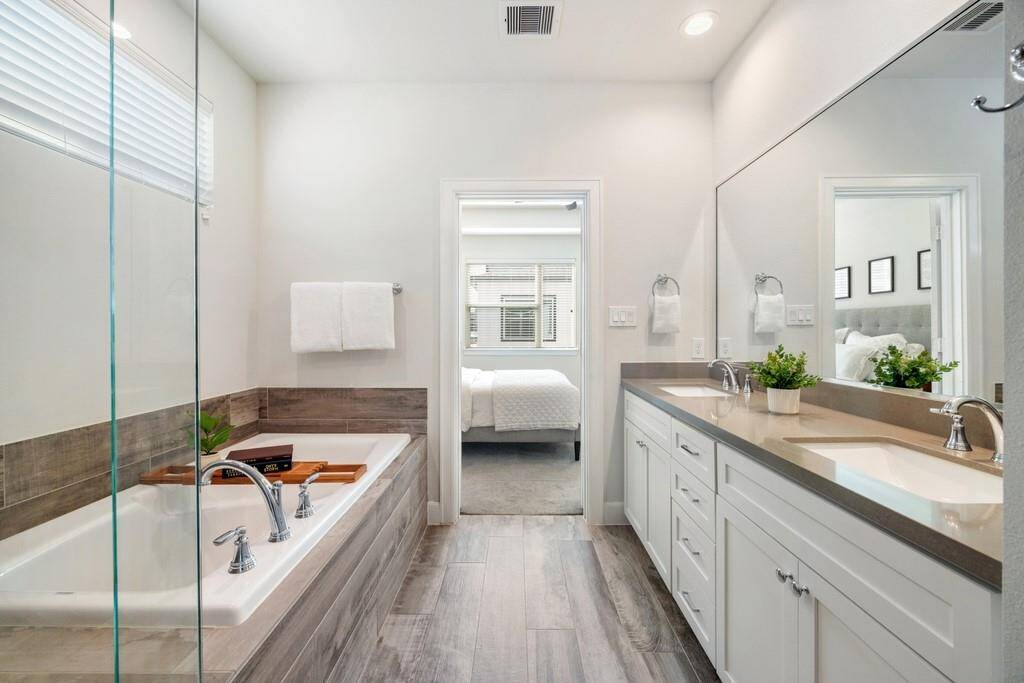 Attached two-car garage featuring epoxy-coated floors and built-in storage.