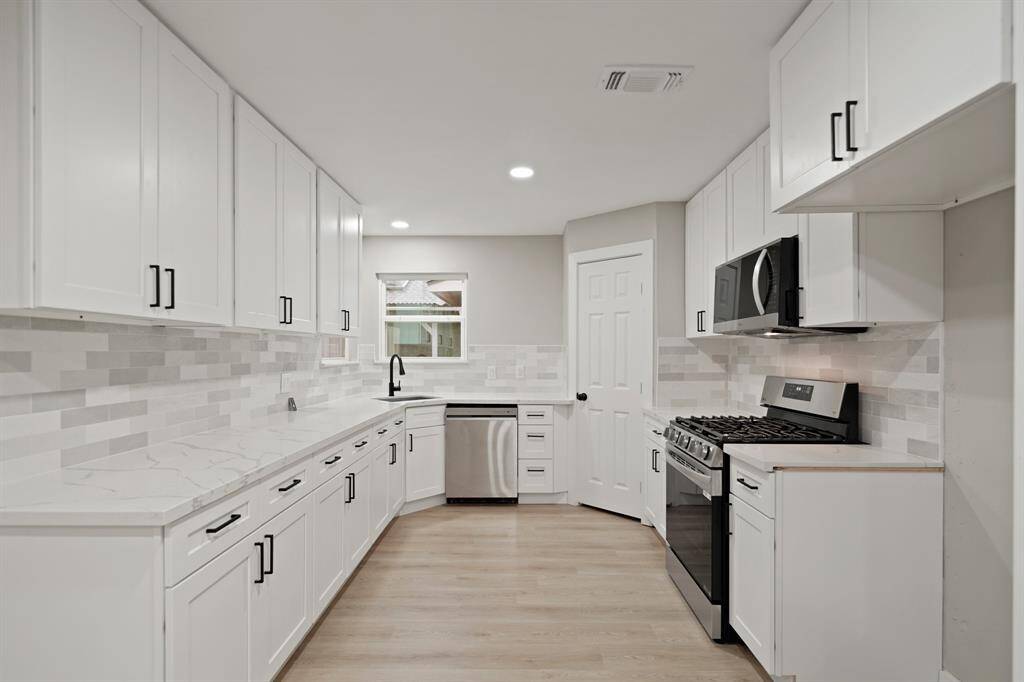 The kitchen is completely remodeled with all new appliances and quartz countertops.