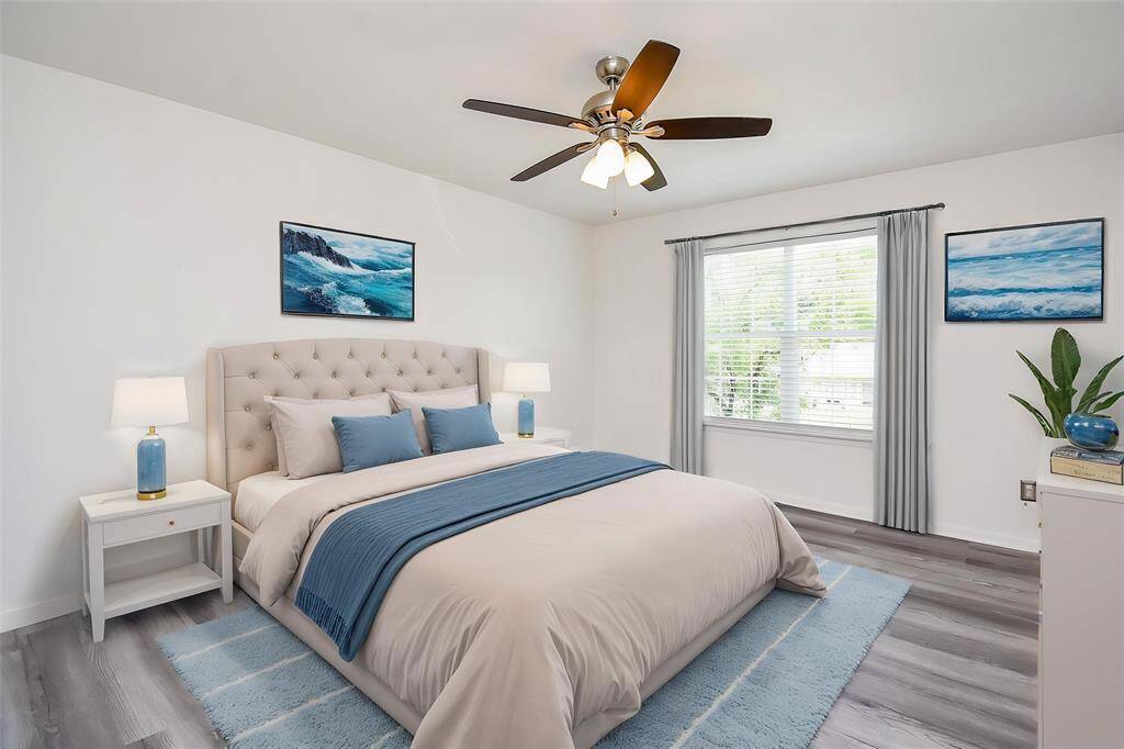 Virtually Staged: This spacious Secondary Bedroom features neutral paint, laminate floors, ceiling fan, and large window with privacy blinds that provides plenty of light throughout the day.