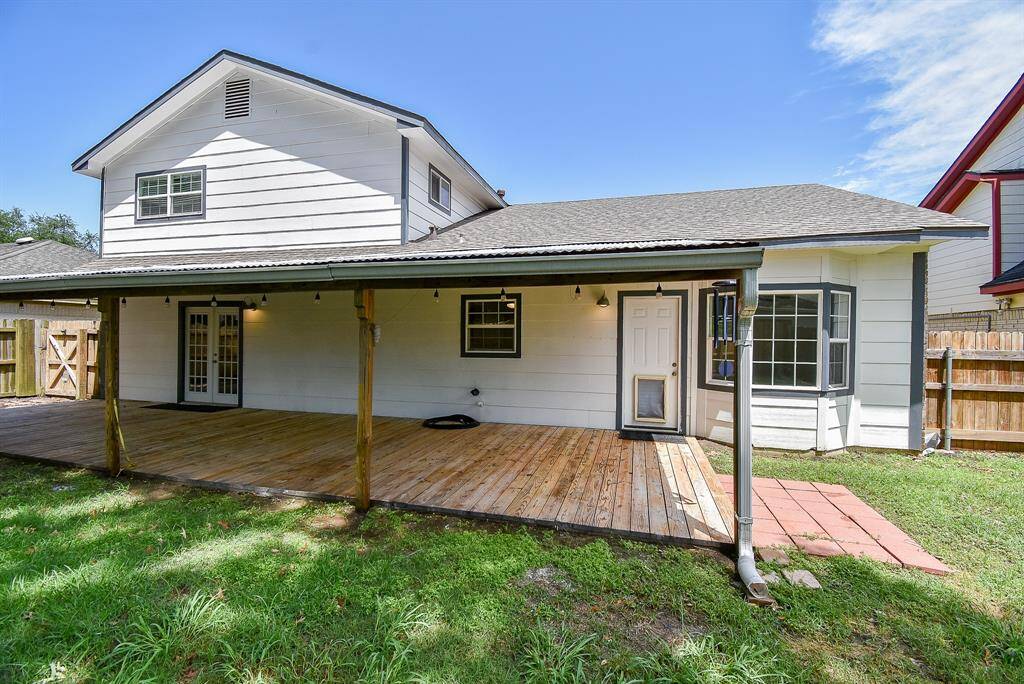 This large backyard features a great patio perfect for outdoor seating and dining.