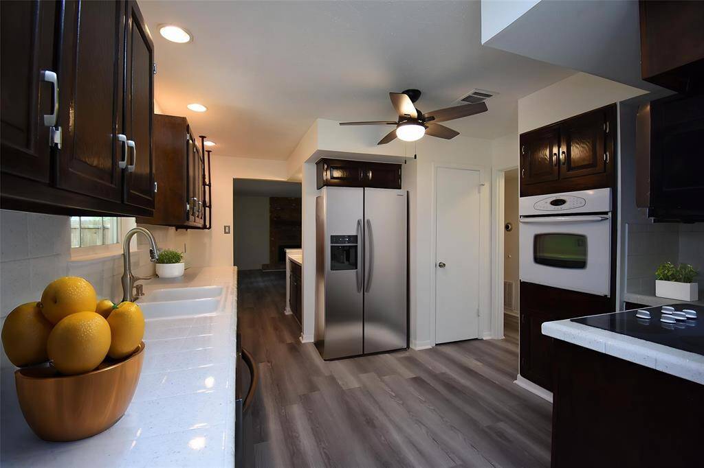 Virtually Staged: This incredible kitchen is pack full of upgrades including new countertops, recessed lighting, a ceiling fan, and new floors!