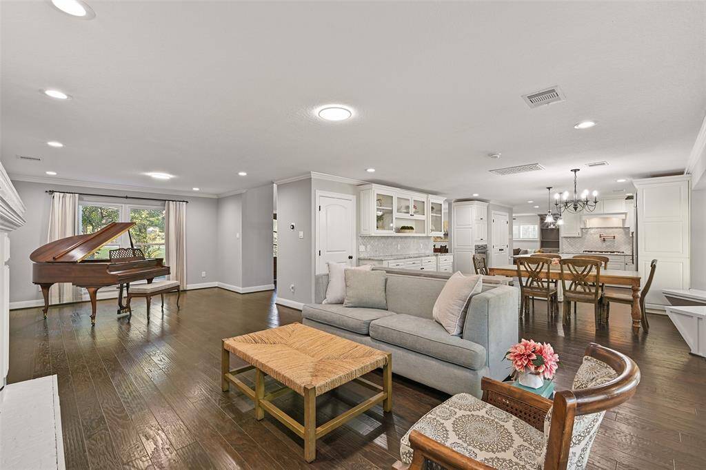 In the same space, looking back towards the front foyer, there is a flex-use extension of this space that is currently used as a music room to house the grand piano. It's also the perfect space for a Christmas tree to be able to be viewed through the front window!