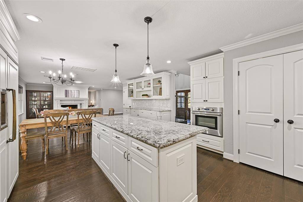 The storage space in this home is truly astounding, and this kitchen is no exception! Notice the roomy double-door pantry, the built-in hutch with glass front cabinetry, and the ample soft-close cabinetry all around.