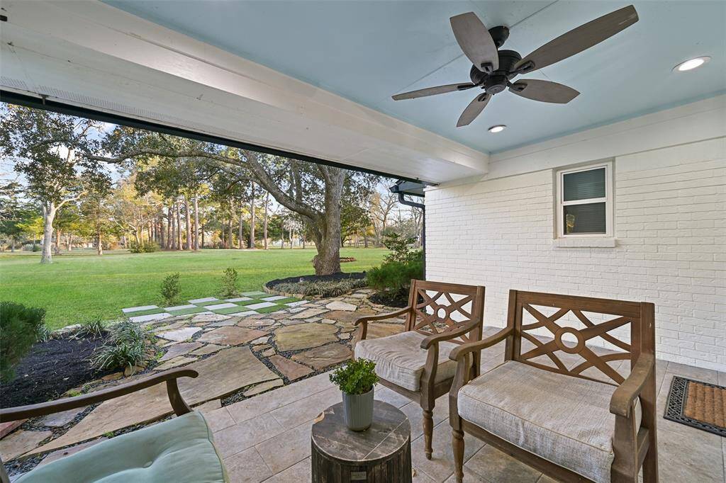 The owners' suite has it's own private front-facing covered patio with a ceiling fan, recessed lights, tile floors, and a flagstone path extending out into the front yard and around towards the front porch. What a great spot to unwind at the end of a long day!
