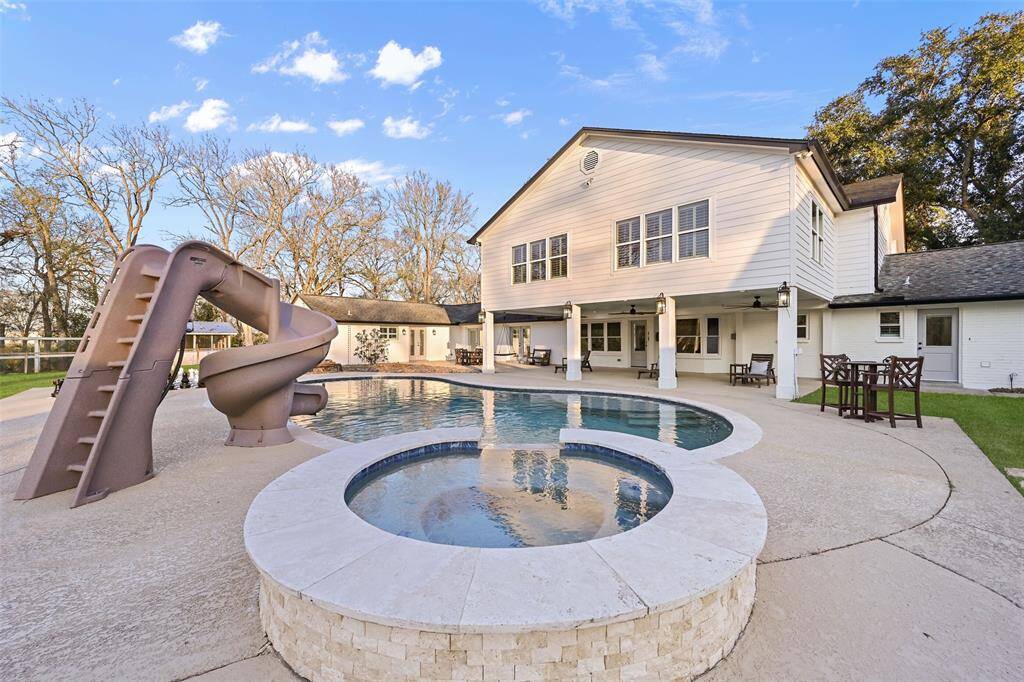 Step outside to enjoy a true oasis that includes a sparkling pool and spa with travertine coping and ample stamped concrete cool decking. Relax beneath the covered patio while you watch the little ones slip and slide on the high adventure pool slide.