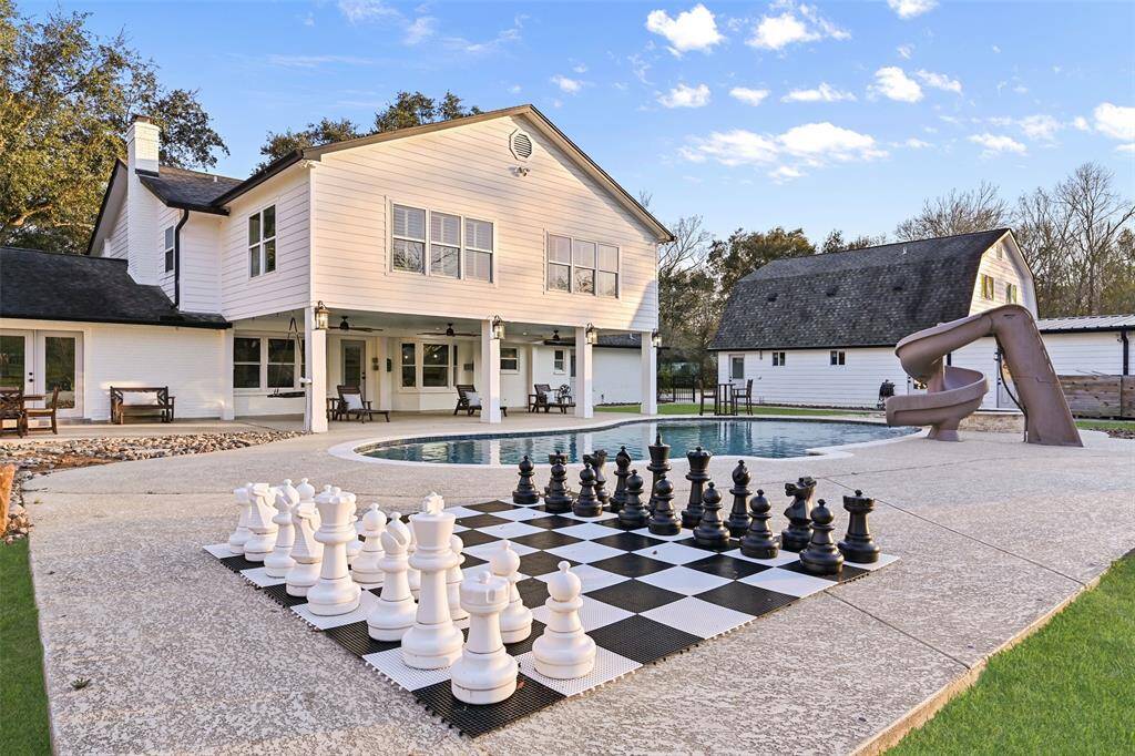 This backyard is all about fun and games! Check your mate in this life-size game of chess, enjoy games under either of two shady patios, or just enjoy the room to run! Head over to the top-notch chicken coop with a fully fenced yard to protect the chicks from predators.