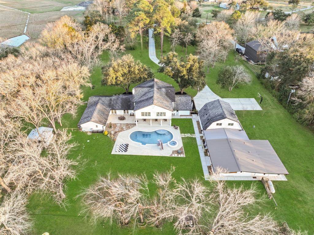 One last glance at this sprawling 4.45-acre property bordered by banks of Chigger Creek highlights over 5,000 square feet of living space and amenities and bonus spaces galore. It's a one-of-a-kind find in Friendswood ISD!