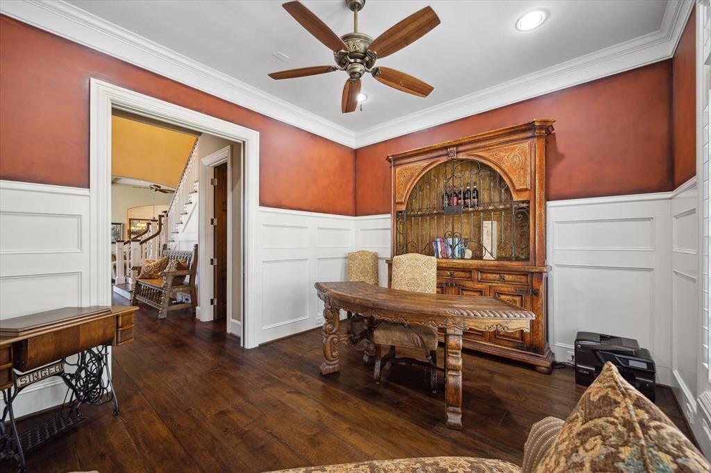 A study with beautiful 9" Estate Grade French Oak floors, tasteful paneling and pocket doors offers a private space to work from home.