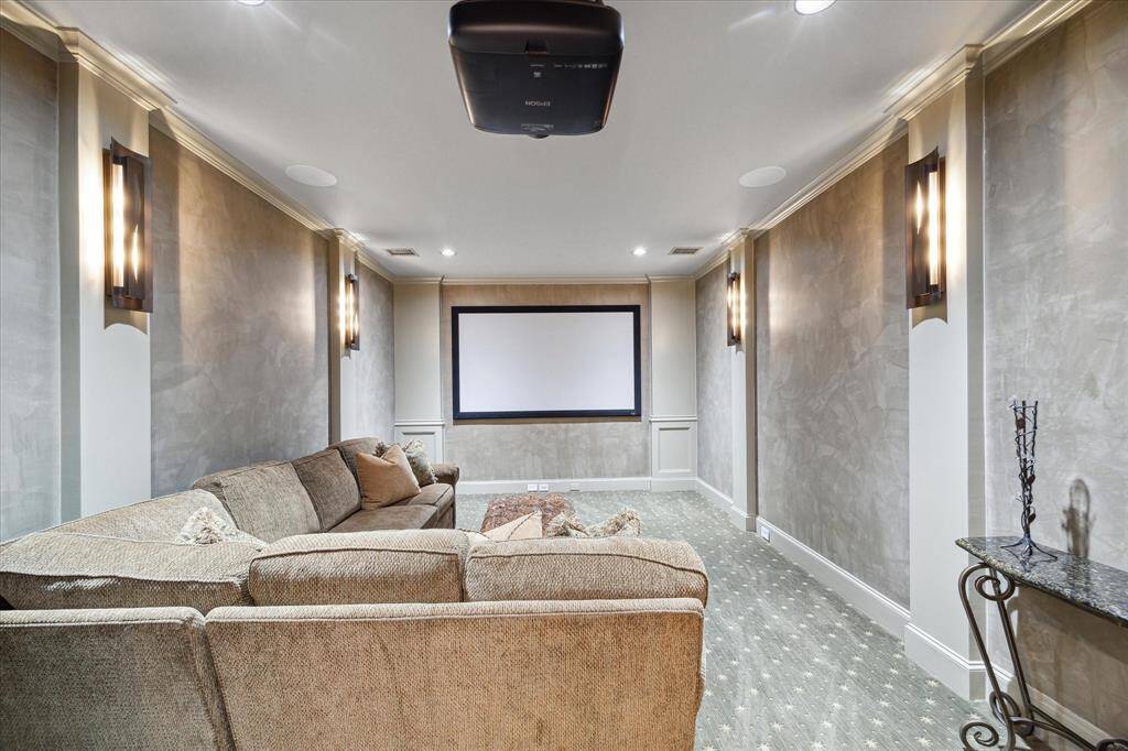 Lovely upstairs media room wtih carpet and wall sconces that create an ideal space for watching your favorite movies, gaming, and  binge watching the newest series!