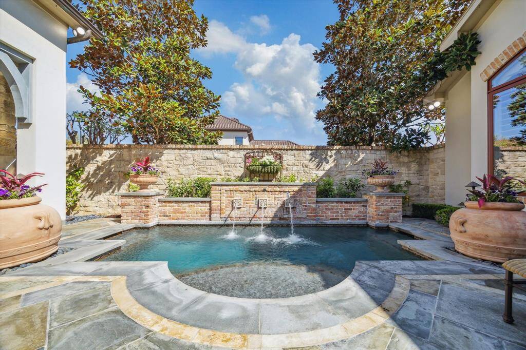 Close up of cocktail pool with tranquil water feature.  This view is enjoyed from the living, dining, kitchen and primary suite.