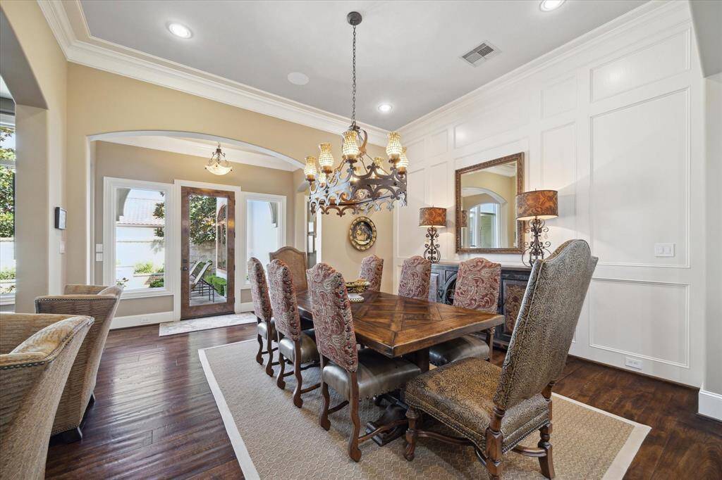 This open concept dining room has great natural light, beautiful paneling with views and access to the pool.
