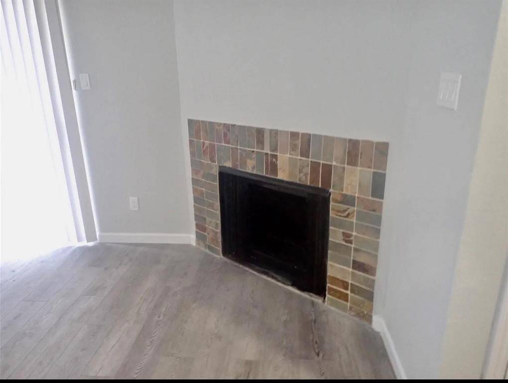 Cozy corner fireplace with stylish tile surround, perfect for warm gatherings.