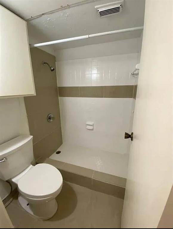 Spacious bathroom with modern fixtures and a sleek design.