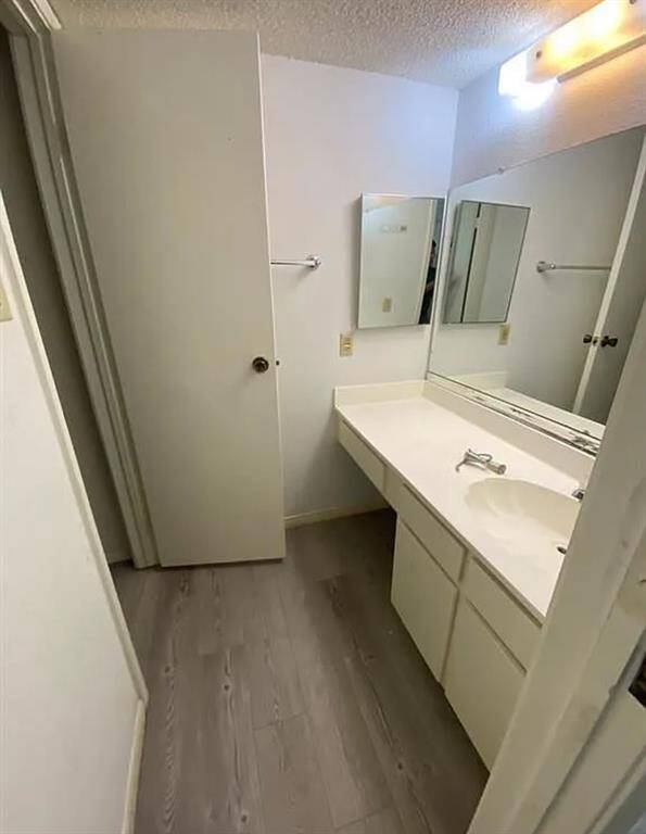 Modern and inviting bathroom with sleek flooring and ample counter space for your convenience.