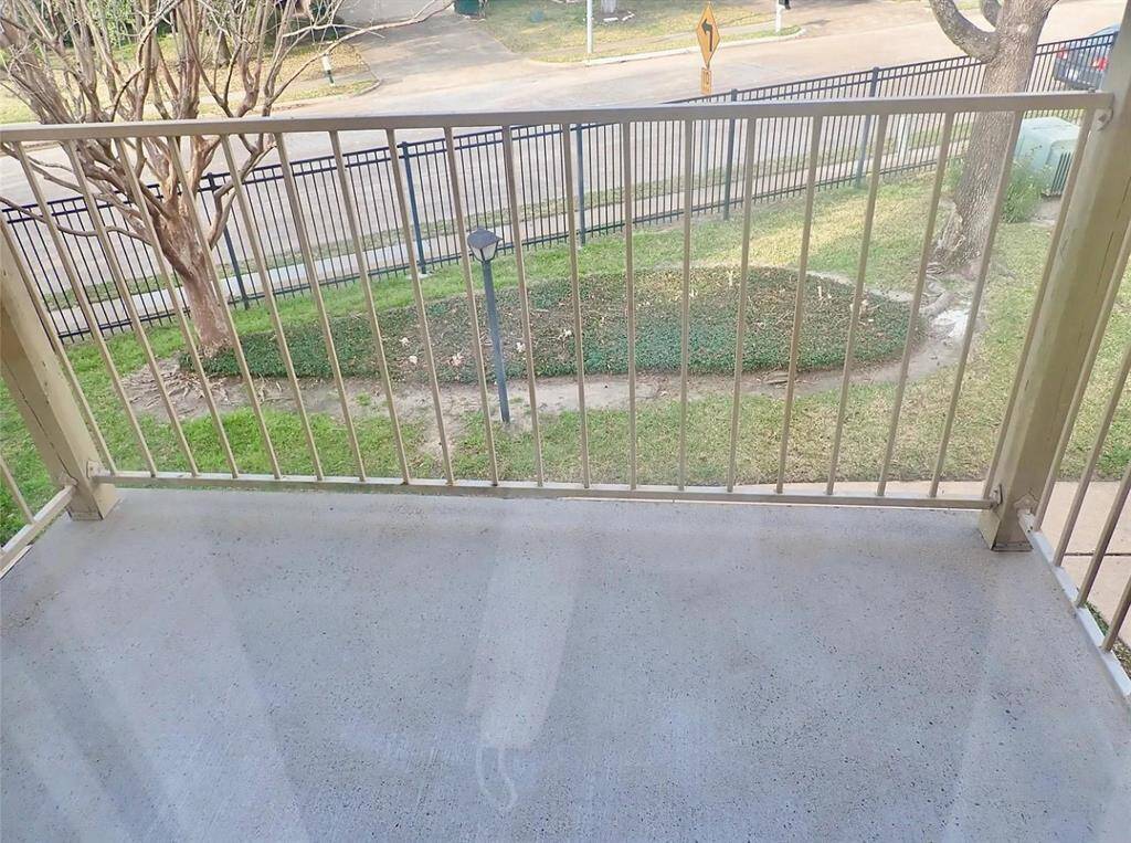 Charming balcony overlooking a lush green space, perfect for relaxation and enjoying the outdoors.