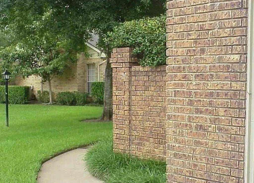 Lush greenery and charming brick accents create a welcoming and serene environment for your new home.