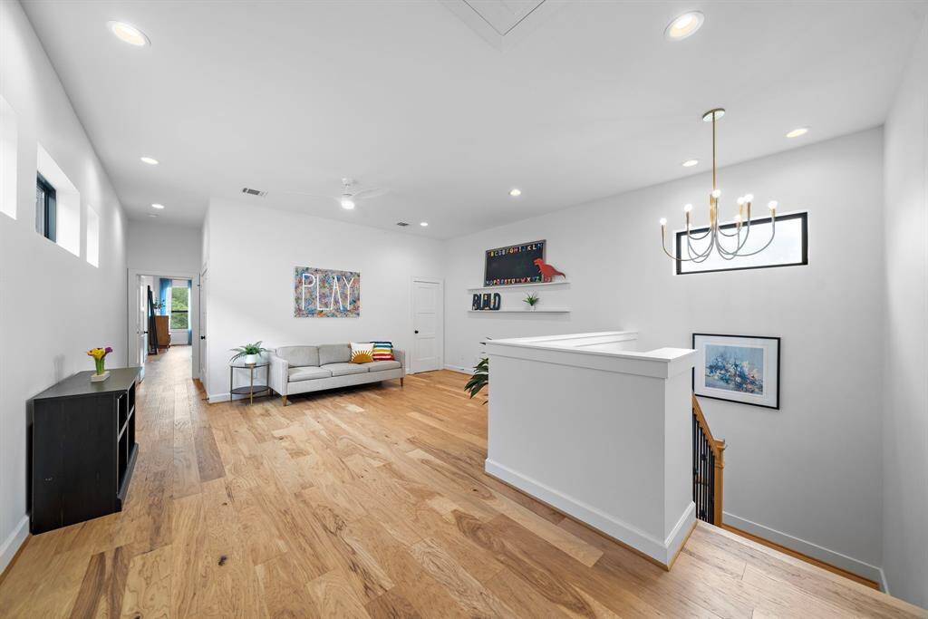 Thoughtfully placed between bedrooms, the upstairs flex space enhances the home's versatility, with open sightlines and layered lighting that make it both functional and inviting.