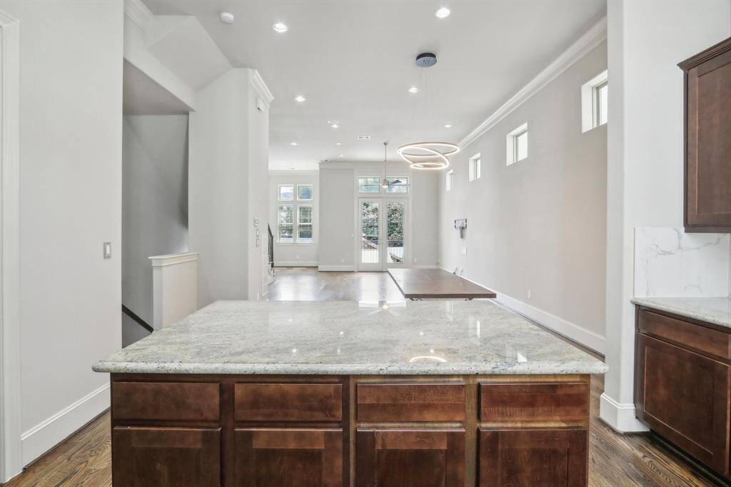View of the kitchen looking into the dining/living room combo. Open concept with lots of windows
