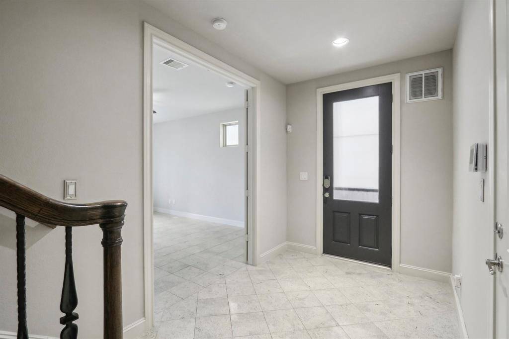 Entrance as you walk in from the first floor. Leads to a bedroom with en suite bathroom and patio deck/fenced yard. Inside of house was freshly painted