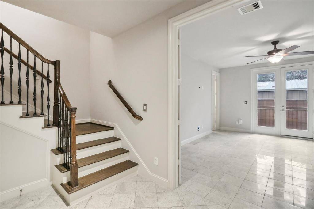 Another view of the bedroom and french door leading to backyard with a deck.