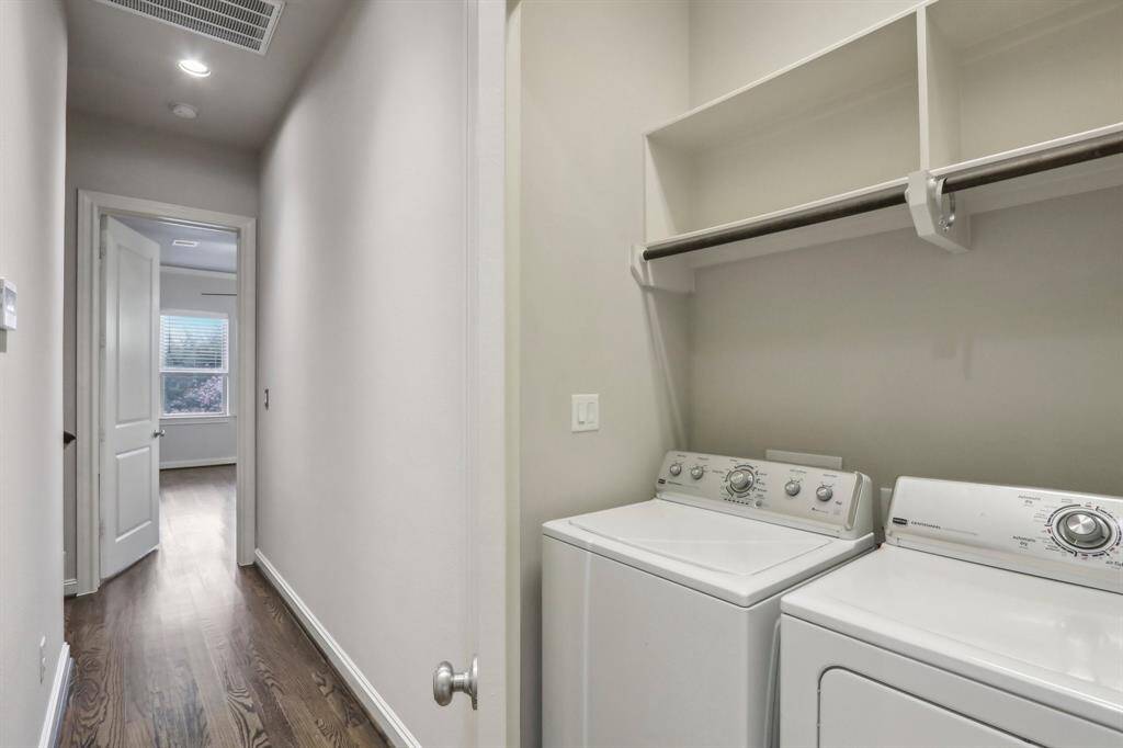 French doors that open to the washer/dryer on the 3rd floor and included with the house. Shelves and rods to store cleaning products and hang your clothes to dry.
