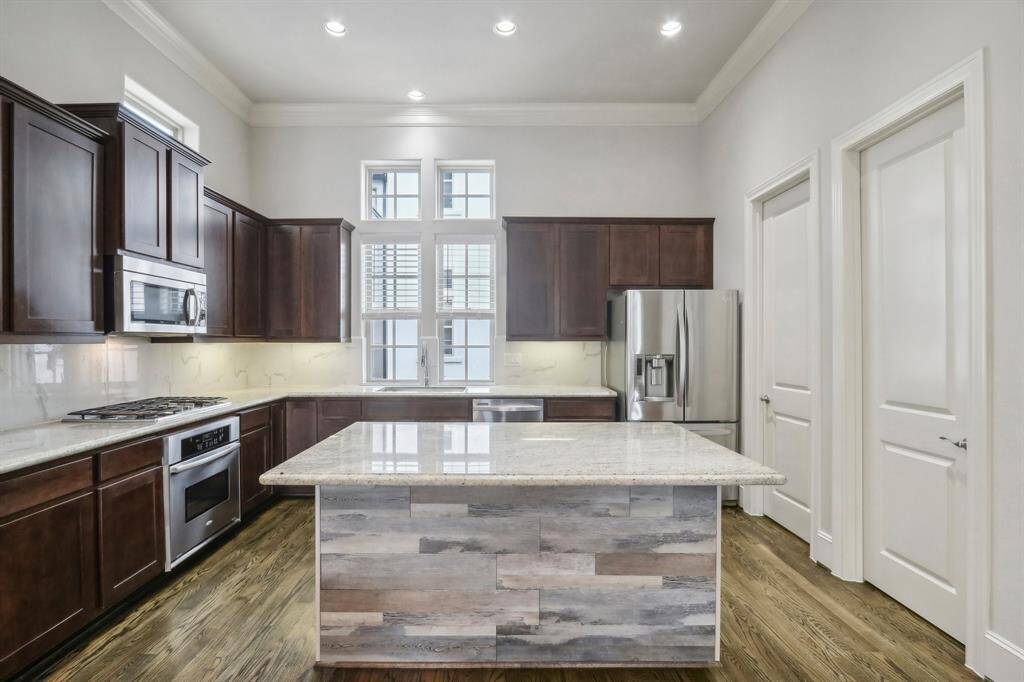 Great kitchen set up that features granite countertops, under cabinet lights, an island with bar seating, a spacious walk in pantry plus a half bath. Bonus, refrigerator included.