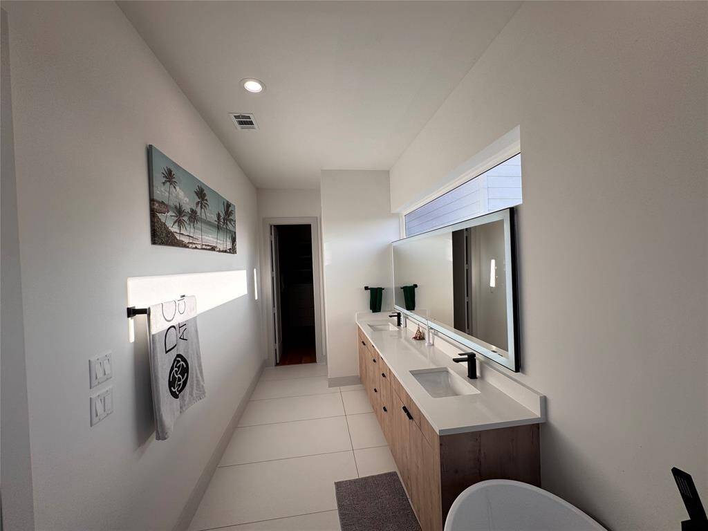 Primary bathroom with massive east facing window- joy to wake up to some natural light plus backlit and front-lit minimalist mirror
